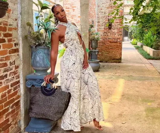 Black woman on luxury vacation, wearing black-owned resort wear | BonVie magazine